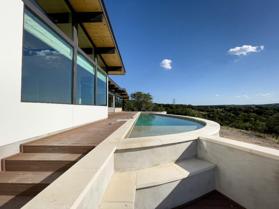 Curved white terrace with stone steps overlooking the sea